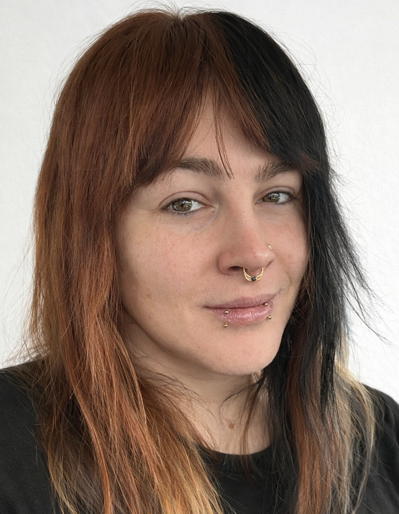 A photograph of Juno, who has Calico hair, grinning; with a white background
